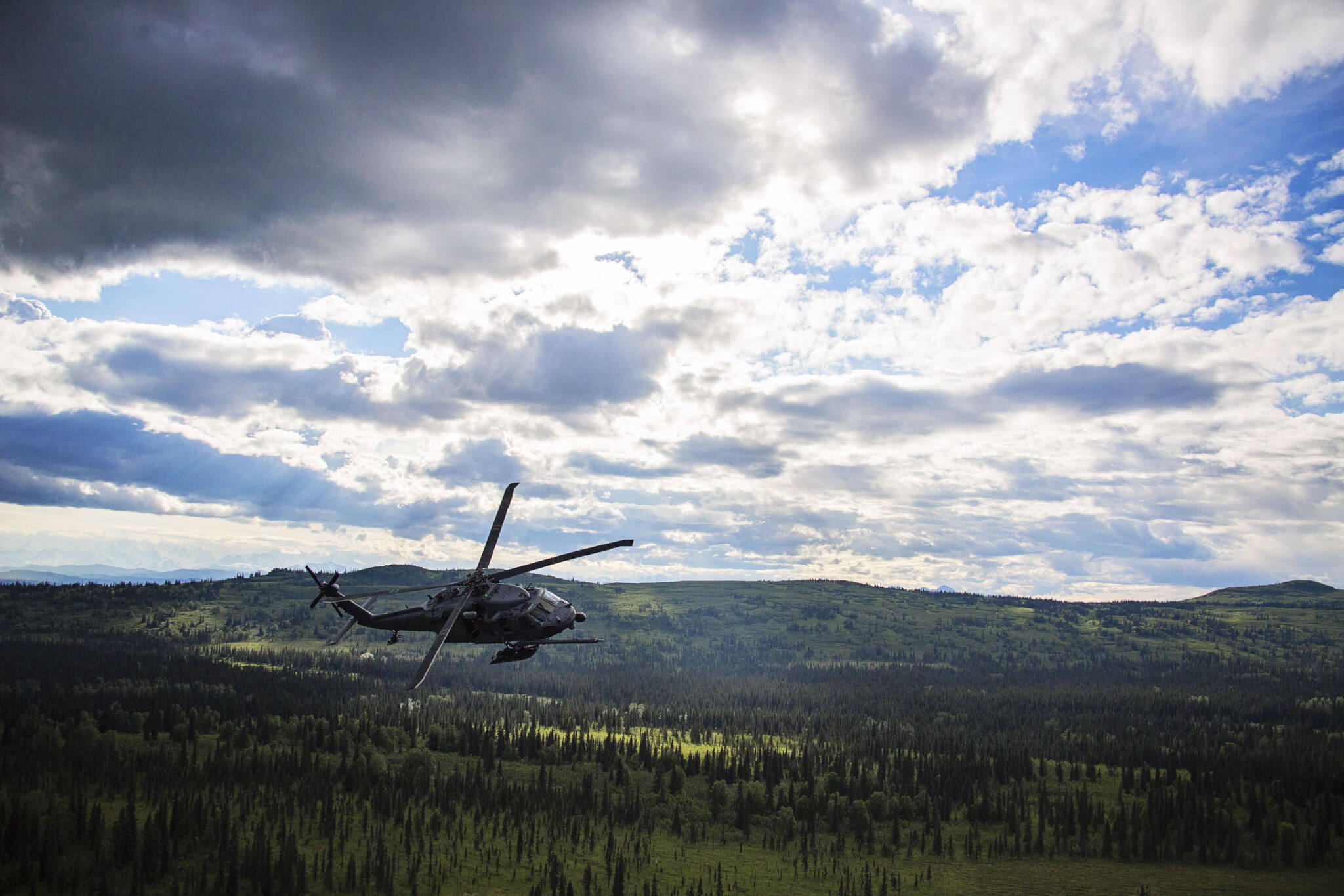 An Alaska Air National Guard HH-60 Pave Hawk, from the 210th Rescue Squadron, performs a simulated search and rescue pattern in Alaska. The 210th Rescue Squadron is part of a network of search-and-rescue organizations that save hundreds of lives in and around Alaska every year. Photo by Alaska National Guard
