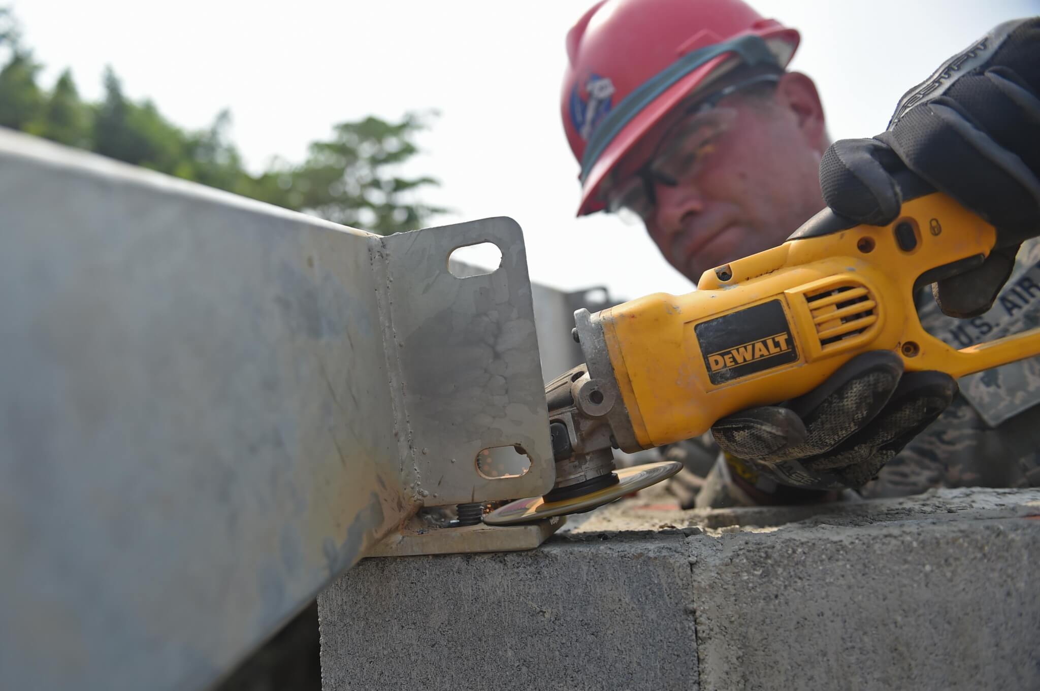 Pennsylvania National Guard Senior Master Sgt. Ronald Hinsey, 201st Rapid Engineer Deployable Heavy Operational repair Squadron Engineers structures superintendent, grinds a mounting plate to size for a new medical clinic. Photo by Senior Airman Dillon Davis