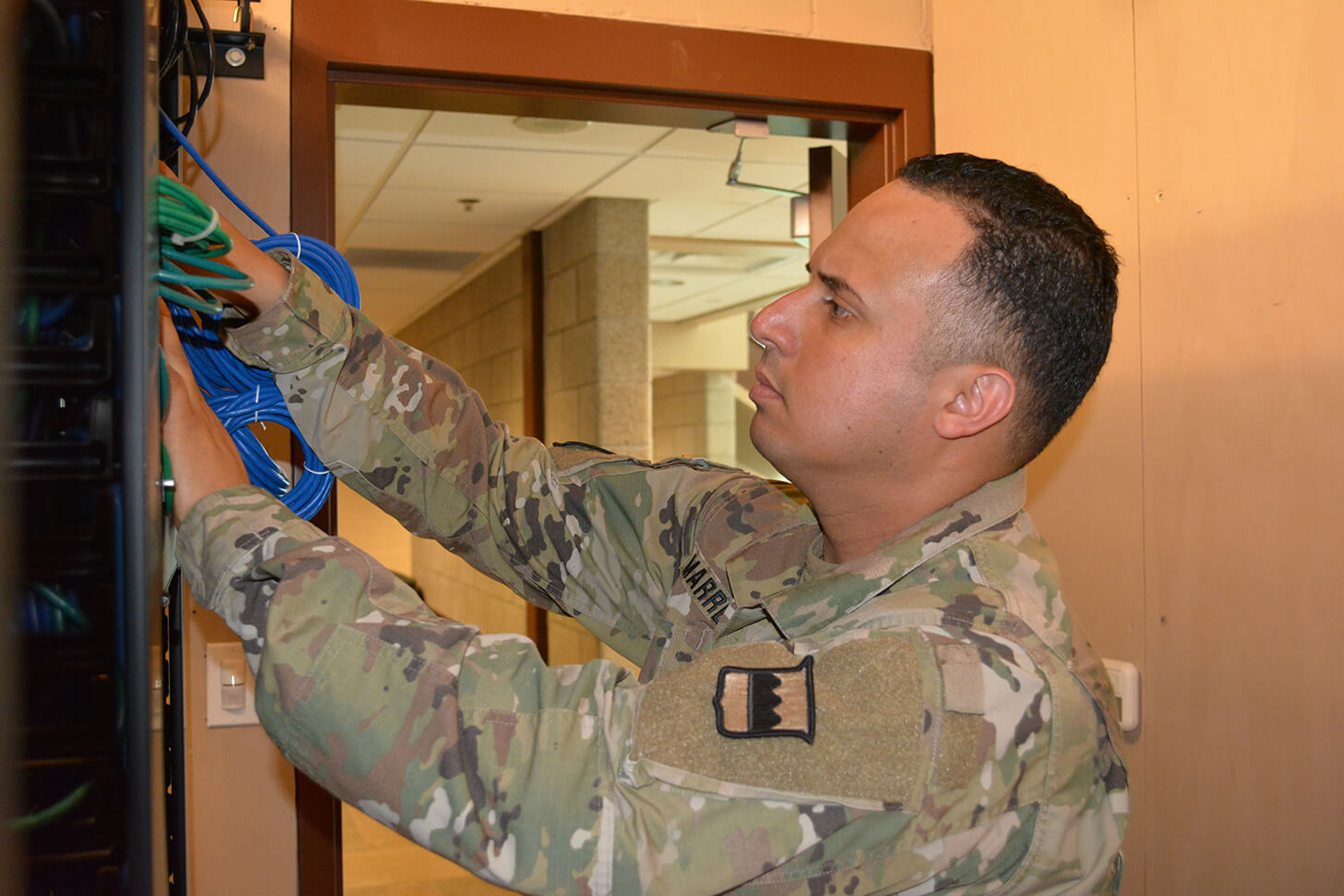 Staff Sgt. Hector Marrero, an Information Technology Specialist assigned to the 80th Training Command, trouble shoots computer connectivity in The Army School System Training Center’s Network Operation Command, Grand Prairie, Texas, March 7, 2016.