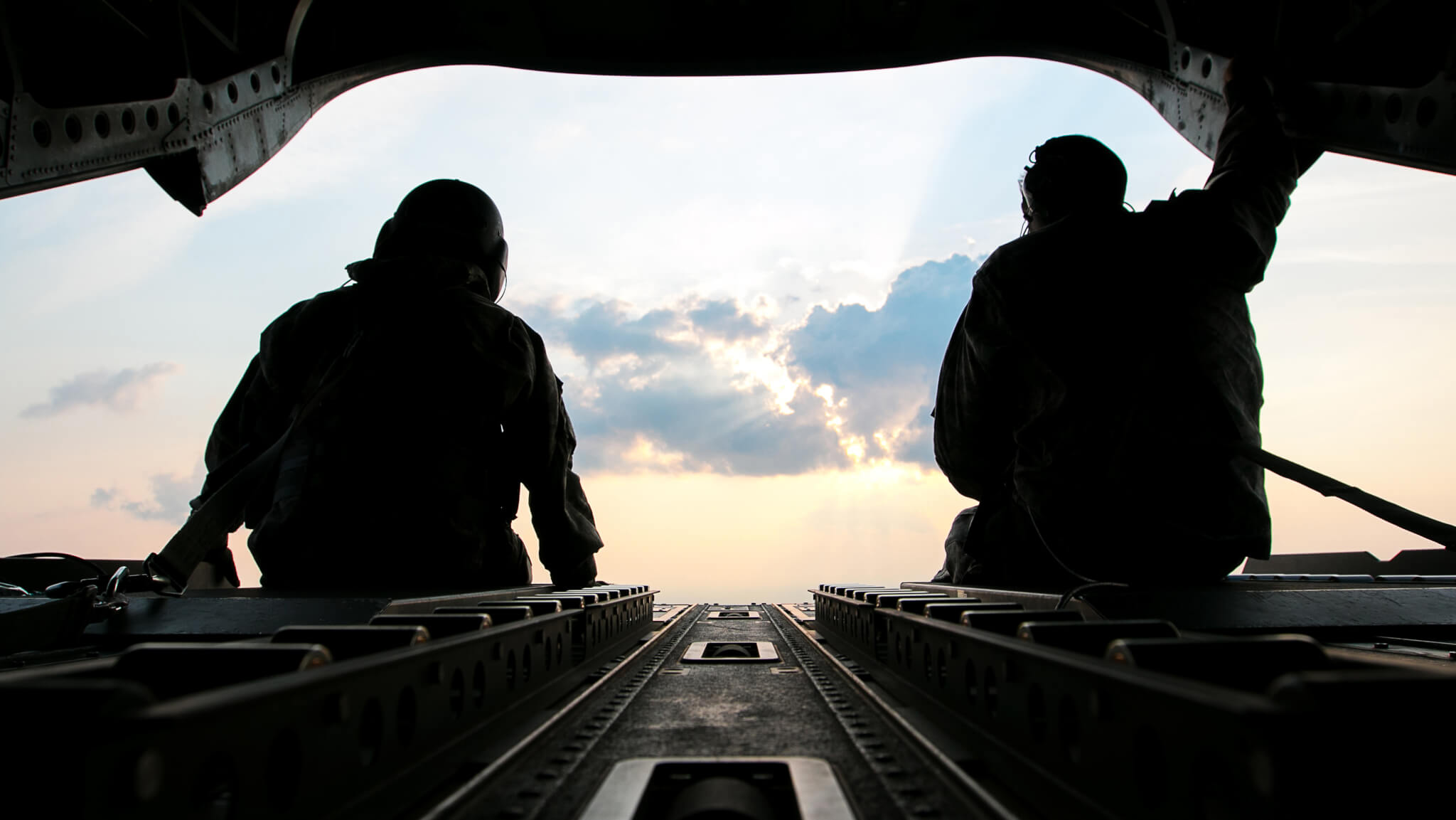 U.S. Army Sgt. 1st Class Roy Chandler, left, and Spc. Benjamin Grogan, assigned to Bravo Company, 1st Battalion, 169th Aviation Regiment, Alabama Army National Guard, sit on the tail of a CH-47 Chinook helicopter in route to deliver hay bales to cattle that have been stranded by Hurricane Harvey near Hampshire, Texas, Sep. 3, 2017. The Department of Defense is conducting Defense Support of Civil Authorities operations in response to the effects of Hurricane Harvey. DSCA operations are part of the DoD’s response capability to assist civilian responders in saving lives, relieving human suffering and mitigating property damage in response to a catastrophic disaster. (U.S. Army photo by Spc. Dustin D. Biven)