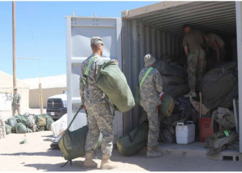 Photo: Soldiers with 2d Battalion, 137th Infantry
Regiment, Kansas Army National Guard, load duffle bags
into a shipping container at the Rotational Unit Bivouac
Area after spending two weeks in “the box” at the
National Training Center. The 2-137th, based in Kansas
City, Kansas, is an organic element of the 155th Armored
Brigade Combat Team, Mississippi Army National Guard.
Mississippi National Guard photo by Spc. Christopher
Shannon, 102d Public Affairs Detachment