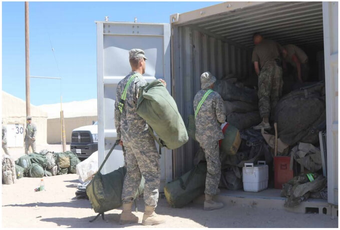 Photo: Soldiers with 2d Battalion, 137th Infantry
Regiment, Kansas Army National Guard, load duffle bags
into a shipping container at the Rotational Unit Bivouac
Area after spending two weeks in “the box” at the
National Training Center. The 2-137th, based in Kansas
City, Kansas, is an organic element of the 155th Armored
Brigade Combat Team, Mississippi Army National Guard.
Mississippi National Guard photo by Spc. Christopher
Shannon, 102d Public Affairs Detachment