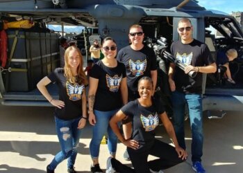 Super Six governing members pictured in front of the helicopter that rescued Navy SEAL Marcus Luttrell.