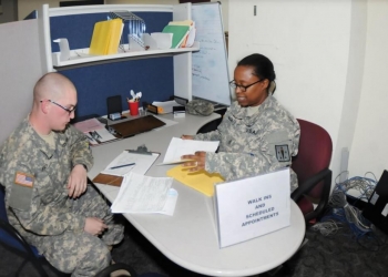 A detailed Soldier processes an advanced individual training student for a tax preparation session at the Fort Lee Tax Assistance Center. Photo by Terrence Bell.