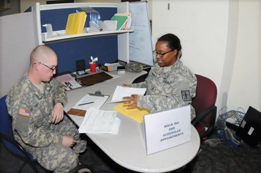 A detailed Soldier processes an advanced individual training student for a tax preparation session at the Fort Lee Tax Assistance Center. Photo by Terrence Bell.