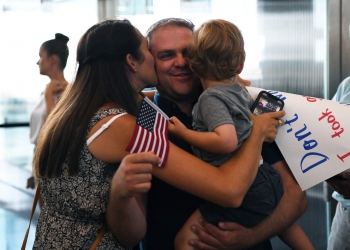 Tech. Sgt. Matthew Annis, 104th Civil Engineering Squadron firefighter, is welcomed home from deployment at Bradley International Airport, Windsor Locks, Connecticut. Photo by Airman 1st Class Sara Kolinski.