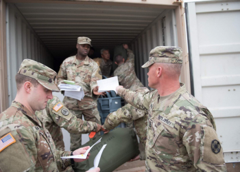 Sgt. Maj. Erick M. Detrich, HHC, 13th ESC Plans Sergeant Major, hands in his duffle bag inventory sheet as he loads his bag in the connex.  As vehicles and equipment begin the process of being transported in support of DEFENDER- Europe 20 and preparations continue, the first wave of Soldiers from 13th ESC will deploy to Eastern Europe this month.