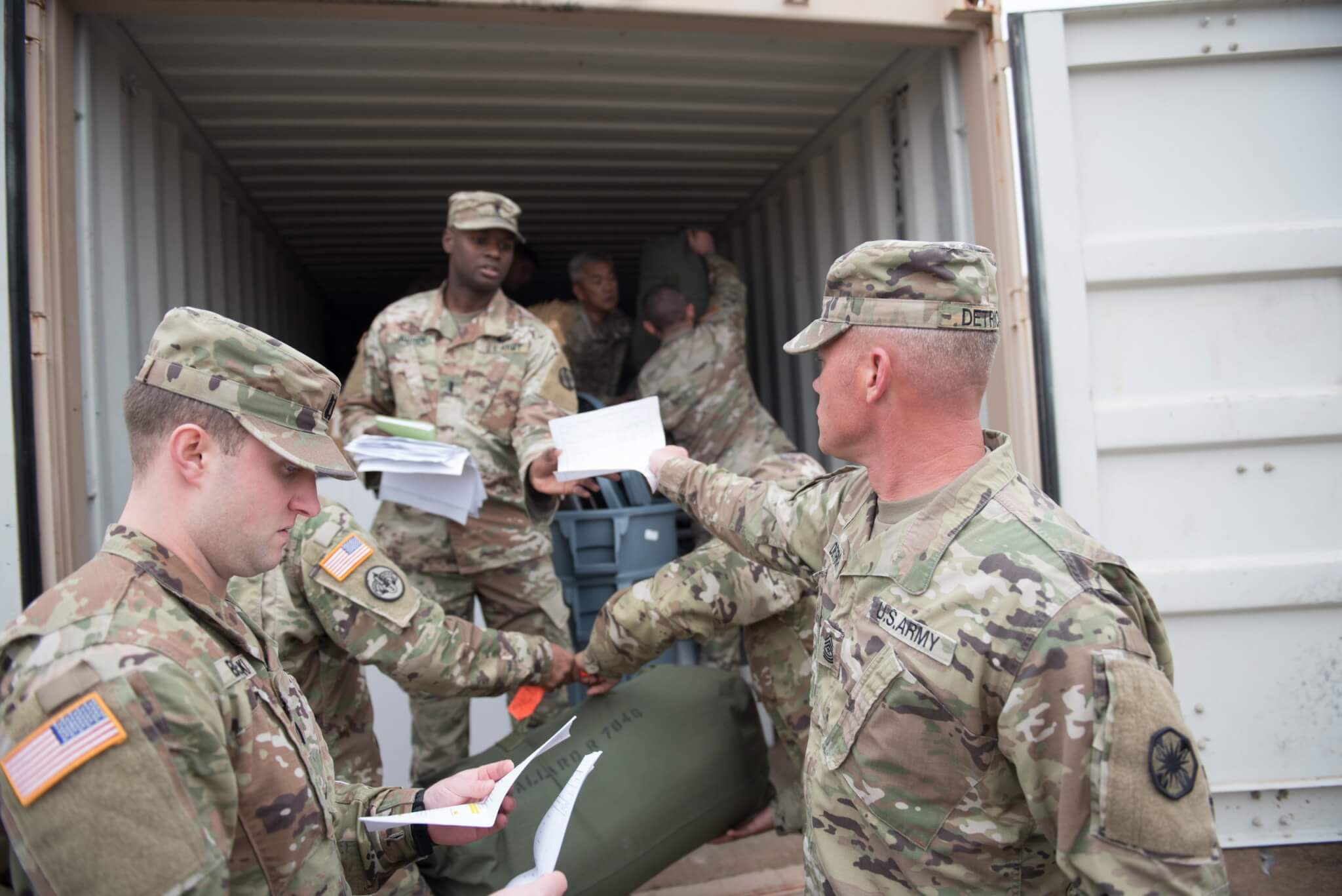 Sgt. Maj. Erick M. Detrich, HHC, 13th ESC Plans Sergeant Major, hands in his duffle bag inventory sheet as he loads his bag in the connex.  As vehicles and equipment begin the process of being transported in support of DEFENDER- Europe 20 and preparations continue, the first wave of Soldiers from 13th ESC will deploy to Eastern Europe this month.