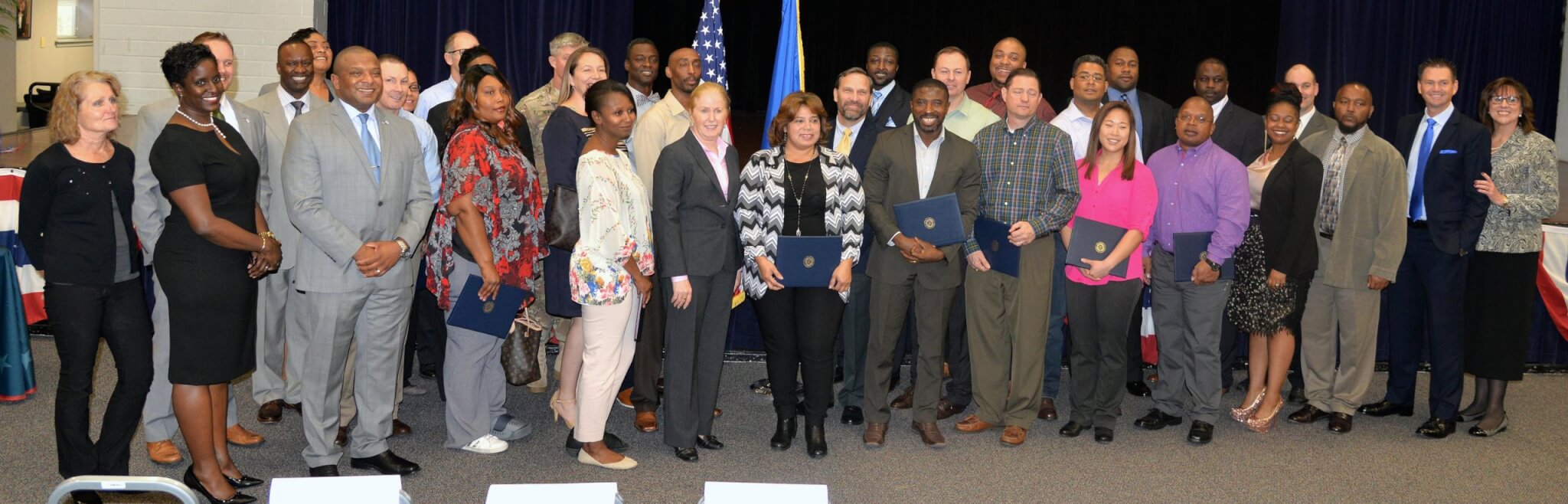 The graduates of the Onward to Opportunity Program and others gather for a group photo at the Joint Base San Antonio-Fort Sam Houston Military & Family Readiness Center Jan. 17. Photo by Steve Elliott