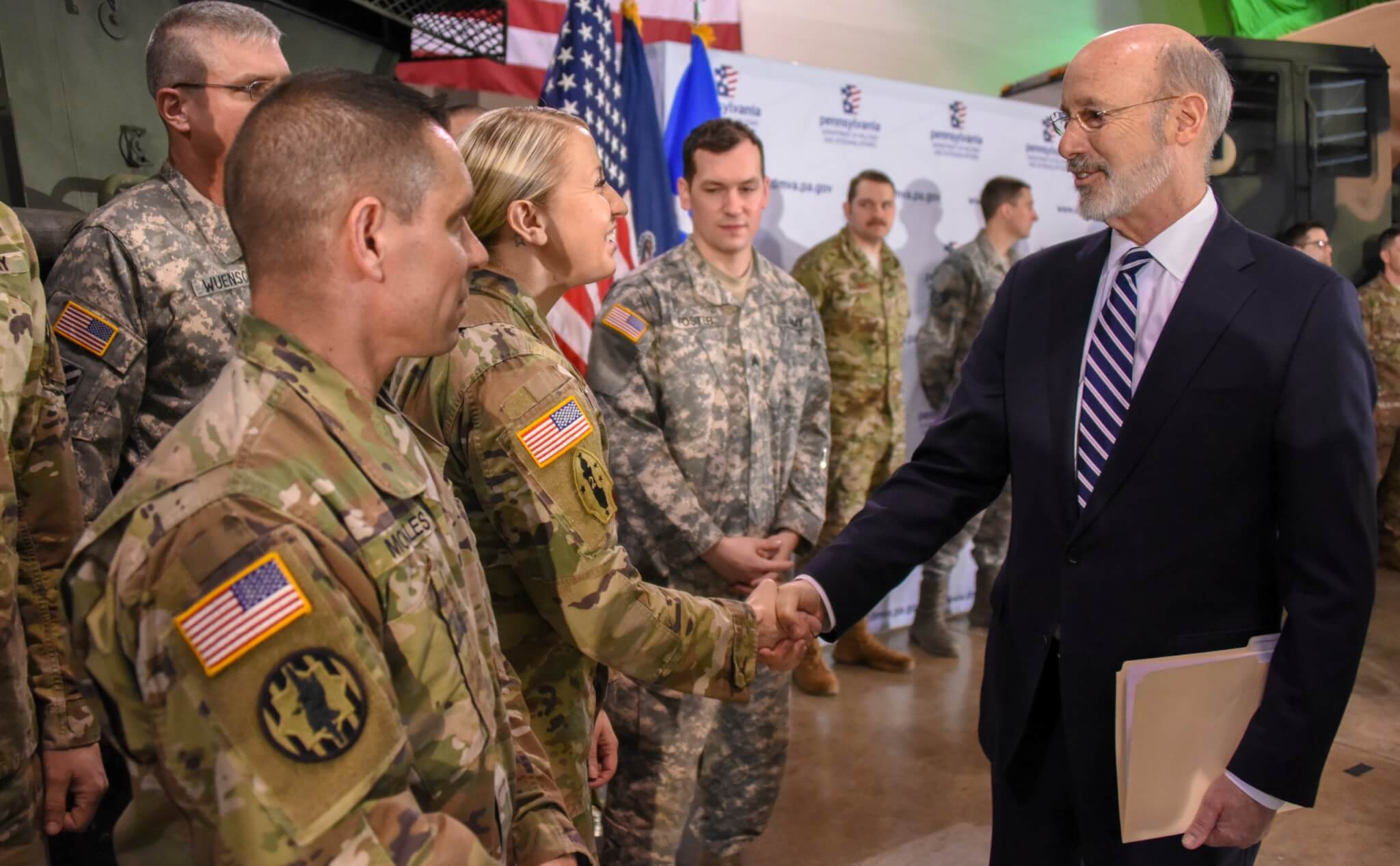 Pennsylvania Gov. Tom Wolf greets members of Pennsylvania National Guard during a press conference on the PA GI Bill. (Department of Military and Veterans Affairs photo by Tom Cherry/Released)