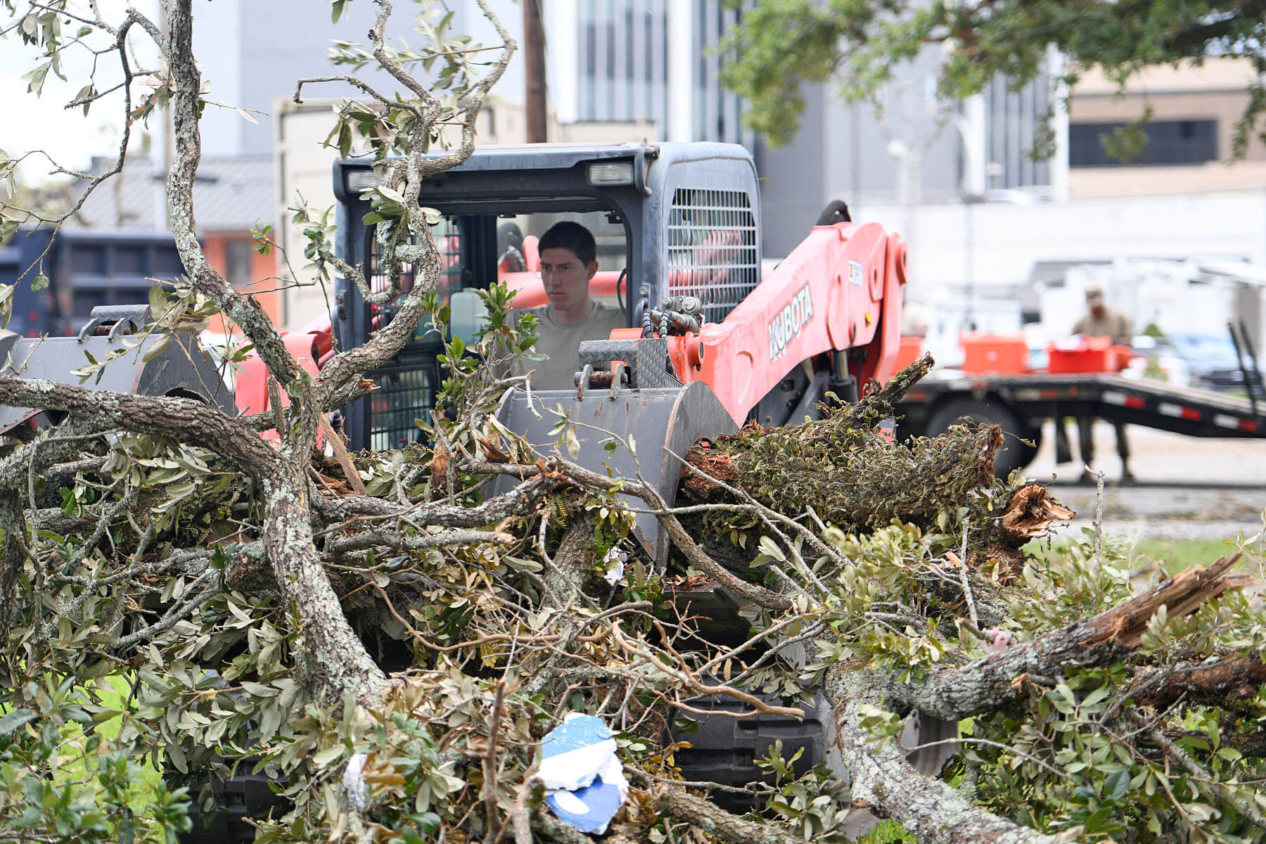 159th Civil Engineering Squadron’s heavy equipment journeyman, Senior Airman William Bommer removes downed tree branches from Hurricane Laura in downtown Lake Charles, La., Aug. 30, 2020.  As part of the 159 CES’s Debris Clearance Package, these Louisiana Air National Guard Airmen were tasked with removing downed trees and rubble for residents to access their homes to assess damages.  (U.S. Air National Guard photo by Senior Master Sgt. Daniel Farrell)