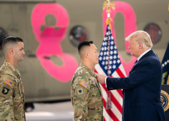 President Trump presents the Distinguished Flying Cross to California Army National Guard member Chief Warrant Officer One Ge Xiong at the Cal Fire Hangar at the Sacramento McClellan Airport in McClellan Park, California. Photo by Shealah Craighead