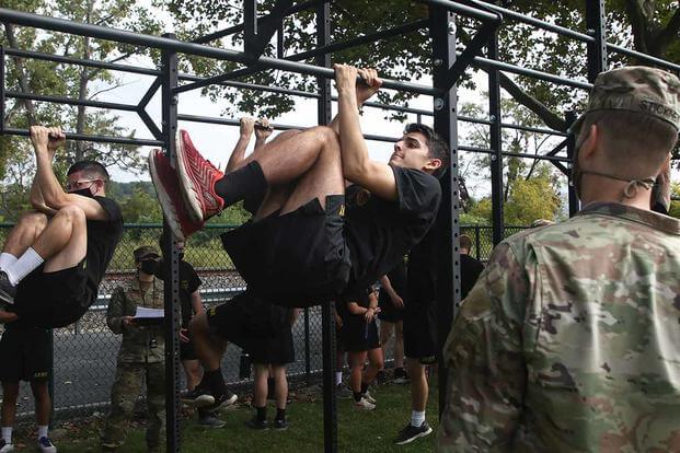 Maj. Nathaniel Stickney counts the amount of leg tucks a cadet performs during the Leg Tuck portion of the Army Combat Fitness Test at West Point, Sept. 6, 2020. (U.S. Army/Eric Bartelt)