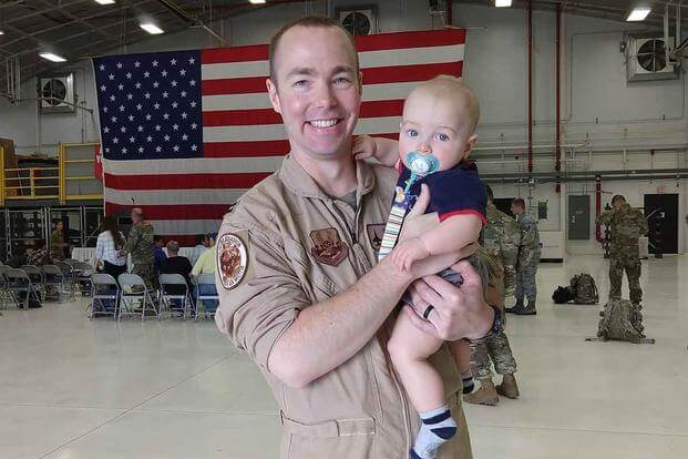 Capt. Durwood “Hawk” Jones, 37, of Albuquerque, New Mexico with his child. (115th Fighter Wing Facebook page)