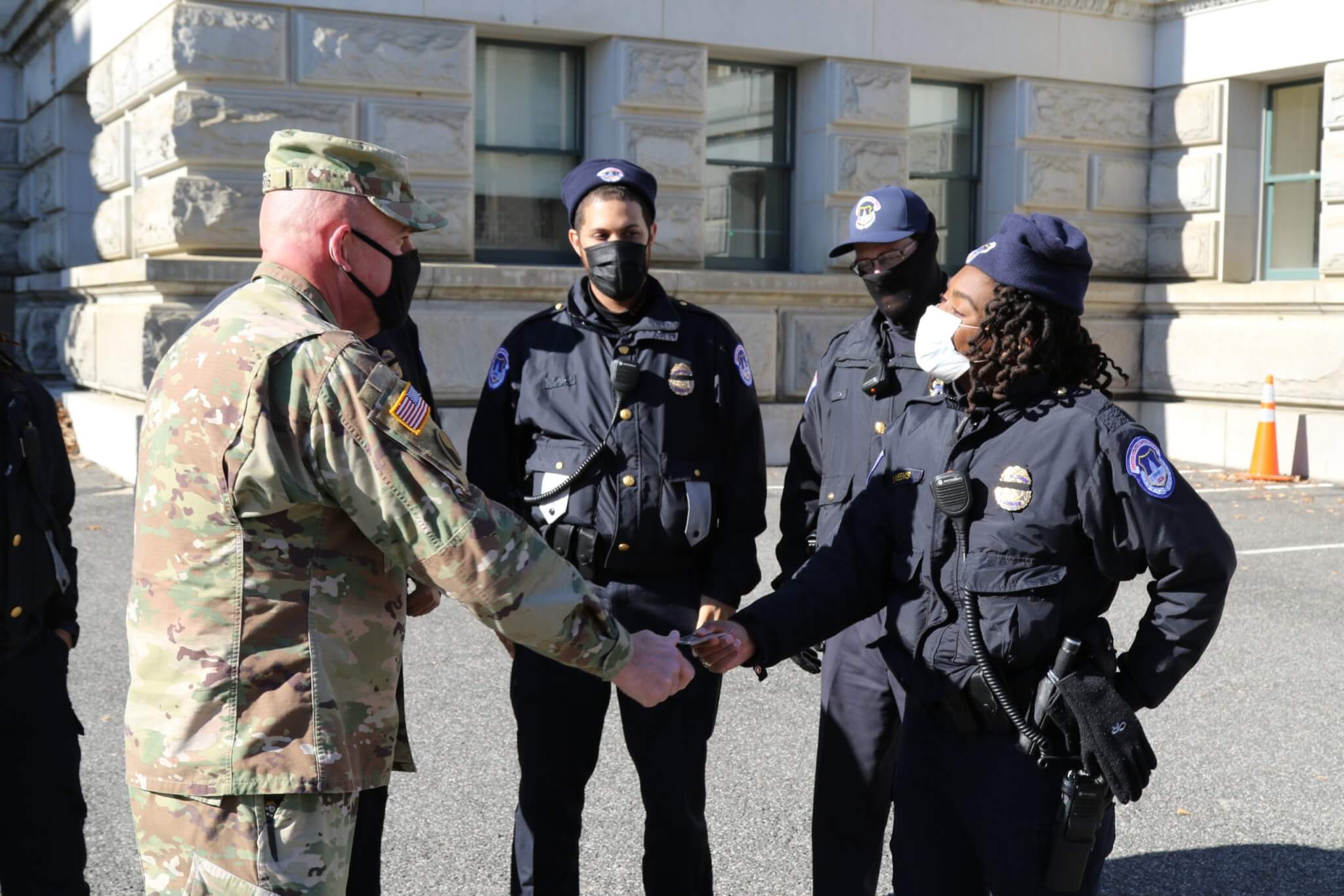 Command Sgt. Maj. Alan Ferris, the 29th Infantry Division Command Sergeant Major, speaks with United States Capitol Police officers while visiting with Virginia National Guard Soldiers assigned to the 229th Brigade Engineer Battalion, 116th Infantry Brigade Combat Team Jan. 10, 2021, in Washington D.C.  National Guard Soldiers and Airmen from several states have traveled to the National Capital Region to provide support to federal and district authorities leading up to the 59th Presidential Inauguration. (U.S. Army National Guard photo by Sgt. Marc Heaton)