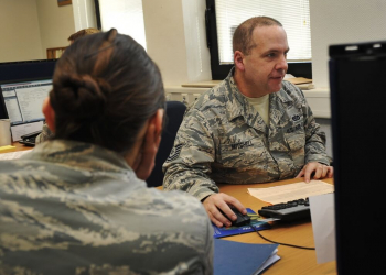 Tech. Sgt. David Mitchell, 786th Civil Engineer Squadron payments and construction equipment NCO in charge, assists Senior Airman Kathryn Patchoski, 569th U.S. Forces Police Squadron police services NCO, with her tax return at the tax center at Ramstein Air Base, Germany. Photo by Airman 1st Class Larissa Greatwood/ 2016.