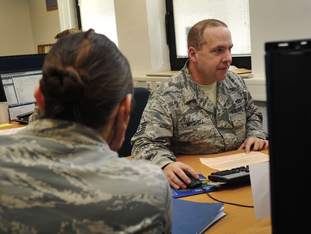 Tech. Sgt. David Mitchell, 786th Civil Engineer Squadron payments and construction equipment NCO in charge, assists Senior Airman Kathryn Patchoski, 569th U.S. Forces Police Squadron police services NCO, with her tax return at the tax center at Ramstein Air Base, Germany. Photo by Airman 1st Class Larissa Greatwood/ 2016.