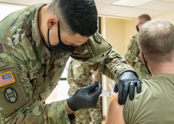Members of the West Virginia National Guard conduct and participate in a COVID-19 vaccination clinic at Joint Forces Headquarters in Charleston, West Virginia. U.S. Army National Guard photo by Edwin L Wriston.