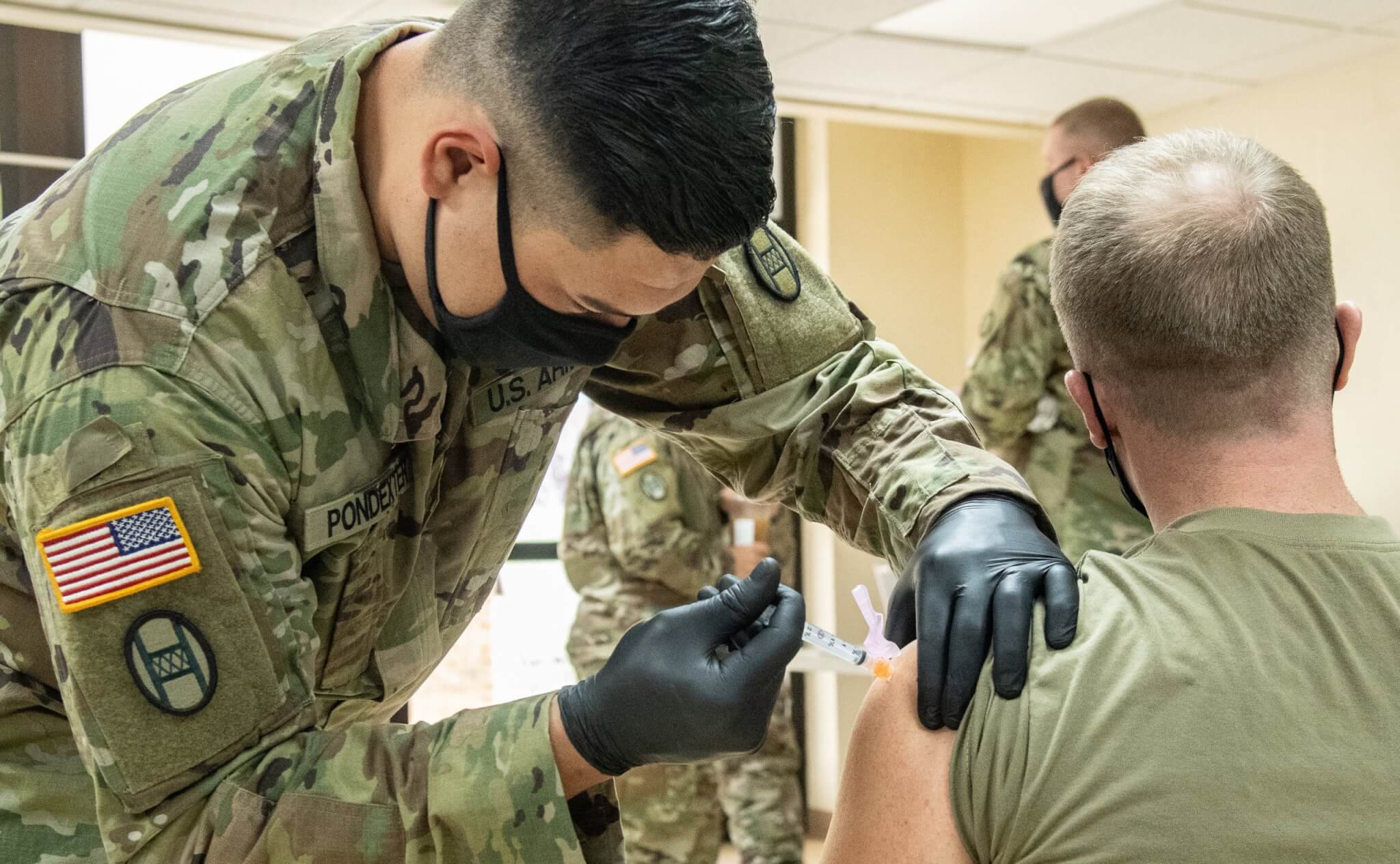 Members of the West Virginia National Guard conduct and participate in a COVID-19 vaccination clinic at Joint Forces Headquarters in Charleston, West Virginia. U.S. Army National Guard photo by Edwin L Wriston.
