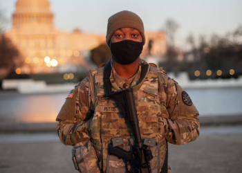 U.S. Army Pfc. Kalen Pettis, Headquarters and Headquarters Company, 156th Expeditionary Signal Battalion, 177th Military Police Brigade, Michigan National Guard, poses for a photo near the U.S. Capitol in Washington, D.C. Army National Guard photo by 2nd Lt. Ashley Goodwin.