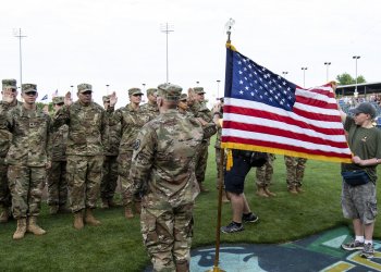 Army Reserve soldiers, with various units in Nebraska, take the oath of enlistment during a mass reenlistment ceremony at an Omaha Storm Chasers baseball game in Papillion, Nebraska, in 2018. The formation consists of 22 soldiers and is the first of its kind in Nebraska. Photo by Sgt. Christopher Jackson.