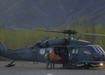 Pararescue personnel with the Alaska Air National Guard’s 212th Rescue Squadron transload an injured hiker from a 210th Rescue Squadron HH-60 Pave Hawk to a Guardian Flight, AirMedCare air ambulance after conducting a multi-agency rescue from an avalanche near Donoho Peak in Wrangle-Saint Elias National Park and Preserve May 26, 2021. (Courtesy photo by Stephens Harper)