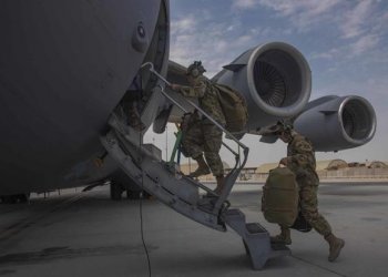 Aircrew assigned to Al Udeid Air Base, Qatar, carry their gear into a C-17 Globemaster III assigned to Joint Base Charleston, South Carolina, April 27, 2021, at Al Udeid AB. (U.S. Air Force/Staff Sgt. Kylee Gardner)