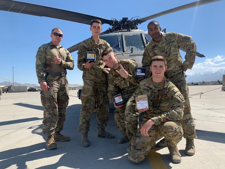 Service members pose with bags of Alpha Coffee. Photo courtesy of Alpha Coffee Company.