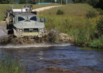 Joint Light Tactical Vehicle driver's training students learn about the fording capabilities of the JLTV while driving through a small river at Fort McCoy, Wis., Sept. 1, 2021. Photo by Sgt. Bill Washburn