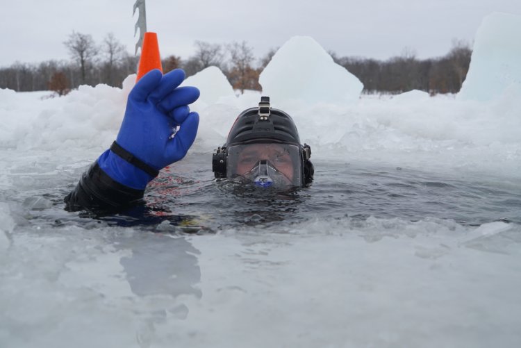 A diver participates in the Coast Guard Ice Diver Training Course in early February 2022 at Camp Ripley, Minnesota.