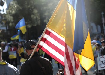 A California citizen walks with the American and Ukrainian flag together at a rally in support of Ukraine on the steps of California’s Capitol building, Sacramento, Calif., March 6, 2022. Photo by Sgt. 1st Class Amanda H. Johnson