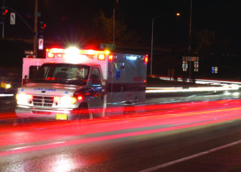 Ambulance standing in night traffic at a motor vehicle accident in early winter, Roseburg Oregon