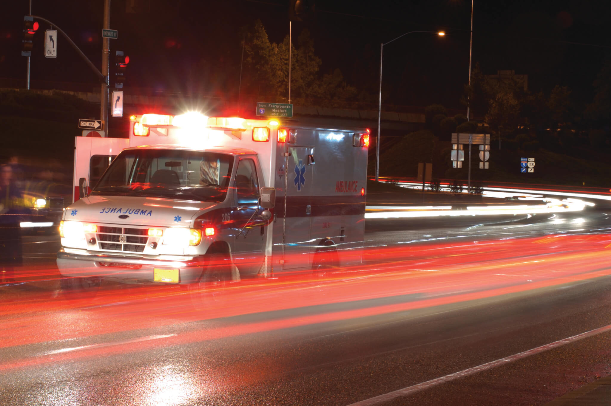 Ambulance standing in night traffic at a motor vehicle accident in early winter, Roseburg Oregon