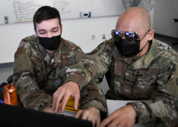 U.S. Air Force Staff Sgt. Eric Pursley, left, and Tech. Sgt. Brian Chung, right, both with the California Air National Guard's 261st Cyber Operations Squadron, run through a simulated cyber defense scenario during CyberDawn 20 in Sacramento, California, Aug. 27, 2020.  Soldiers and Airmen from the California National Guard, the Arizona National Guard and the Nevada National Guard are participating in CyberDawn 20 running across all three states. CyberDawn 20 is a two-week exercise designed to provide a tactical level cyber response to defend web based infrastructure and provide team training in Federal Emergency Management Agency Region 9. (U.S. Air National Guard photo by Tech. Sgt. Christian Jadot)