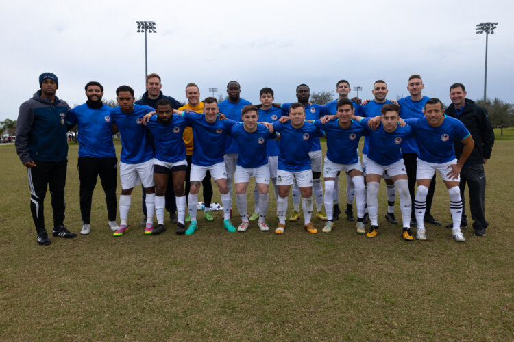 Members of the U.S. Armed Services Football team pose for a group photo at the Lake Myrtle Sports Complex, Auburndale, Florida, Jan. 14, 2024. The team consisted of 17 service members from across the U.S. Armed Forces who were mentored by All-Air Force Soccer coach Jeremiah Kirschman and All-Navy Soccer coach  Jay Reynard. (U.S. Army photo by Sgt. Matthew Lucibello)