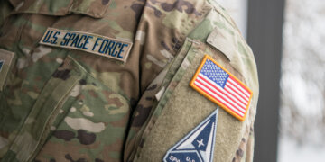 Staff Sgt. David Diehl II, 436th Communications Squadron NCOIC of wing cybersecurity, displays his new Space Force tapes and service branch patch at Dover Air Force Base in 2021. Diehl was one of three members of Team Dover accepted into the Space Force. Photo by Mauricio Campino