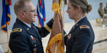 U.S. Army Maj. Gen. Francis Evon, adjutant general for the Connecticut National Guard, hands the flag of the warrant officer cohort from Chief Warrant Officer 4 Stephanie Richard, Connecticut's incoming command chief warrant officer, during a change of responsibility ceremony at the Gov. William A. O'Neill armory in Hartford, Conn. Nov. 3, 2024. Chief Warrant Officer 4 Stephanie Richard replaced Chief Warrant Officer 5 Brian Erkson, becoming the state's first female command chief warrant officer.