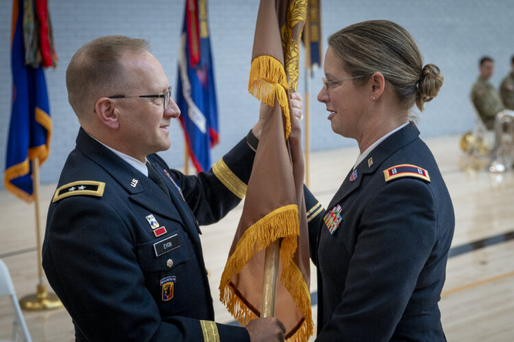 U.S. Army Maj. Gen. Francis Evon, adjutant general for the Connecticut National Guard, hands the flag of the warrant officer cohort from Chief Warrant Officer 4 Stephanie Richard, Connecticut's incoming command chief warrant officer, during a change of responsibility ceremony at the Gov. William A. O'Neill armory in Hartford, Conn. Nov. 3, 2024. Chief Warrant Officer 4 Stephanie Richard replaced Chief Warrant Officer 5 Brian Erkson, becoming the state's first female command chief warrant officer.