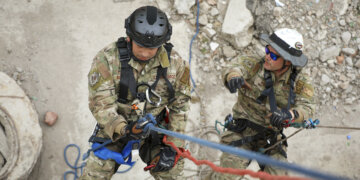 U.S. Air Force Tech Sgt. Frankie Bolaños, left, lowers himself on the line to simulate the rescue of Tech Sgt. Daniel Kolk, both fire contingency instructors with the Pacific Air Force, while demonstrating high-angle rescue techniques during the Field Training Exercise at Gobi Wolf 2024 in Choibalsan, Mongolia, May 9. The teams showcased best practices in safely extracting trapped individuals from precarious situations. Gobi Wolf 24 is part of the Pacific Resilience Disaster Response Exercise and Exchange program, which focuses on interagency coordination and foreign humanitarian assistance and is coordinated by the Mongolian National Emergency Management Agency and U.S. Army Pacific. (U.S. Army photo by Capt. Balinda O’Neal)