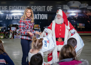 Santa Claus assisted the first lady in distributing tote bags from her Be Best initiative. Photo credit: Photography by Trish Alegre-Smith.