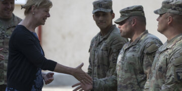 Army Sgt. 1st Class Brandon Kramer assigned to 101st Airborne Division (Air Assault) greets U.S. Sen. Tammy Baldwin of Wisconsin during a visit to Mihail Kogalniceanu Air Base, Romania, July 7, 2022. The delegation traveled to Romania to engage with U.S. forces, gain a better understanding of U.S. strategic efforts in Europe and engage with Soldiers from Wisconsin. (U.S. Army photo by Spc. Dean Johnson, 5th Mobile Public Affairs Detachment)