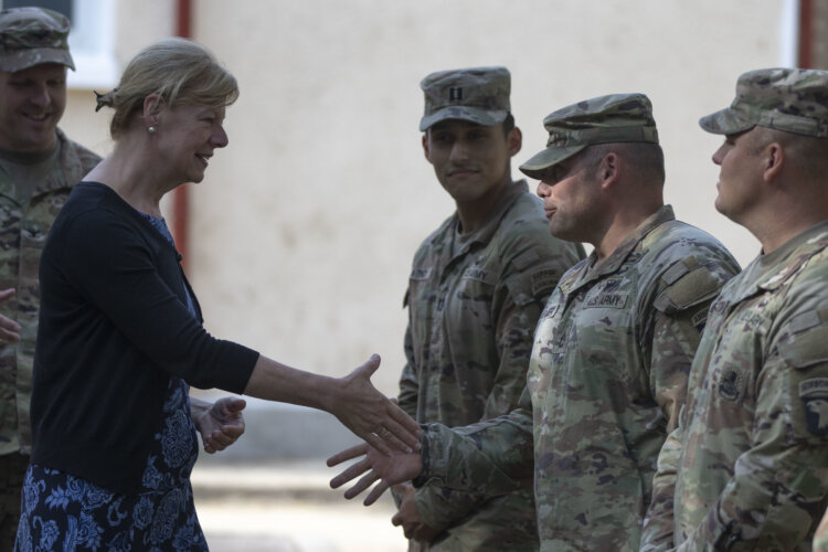 Army Sgt. 1st Class Brandon Kramer assigned to 101st Airborne Division (Air Assault) greets U.S. Sen. Tammy Baldwin of Wisconsin during a visit to Mihail Kogalniceanu Air Base, Romania, July 7, 2022. The delegation traveled to Romania to engage with U.S. forces, gain a better understanding of U.S. strategic efforts in Europe and engage with Soldiers from Wisconsin. (U.S. Army photo by Spc. Dean Johnson, 5th Mobile Public Affairs Detachment)