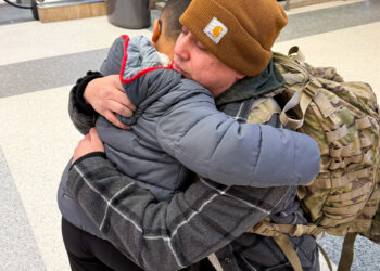 Sarah's husband says goodbye to their son ahead of his deployment. Courtesy photo
