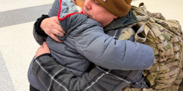 Sarah's husband says goodbye to their son ahead of his deployment. Courtesy photo