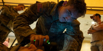 A combat medic assigned to 3rd Battalion, 319th Field Artillery Regiment, 82nd Airborne Division, operates an intercranial hemorrhage assessment device during a Soldier touchpoint event. Battlefield traumatic brain injury assessments and a refreshed Warfighter Brain Health initiative were focal points of discussion during the 2026 Annual Brain Health Symposium, hosted by the Traumatic Brain Injury Center of Excellence. Photo by T. T. Parish