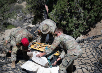 Parachute riggers assigned to 19th Special Forces Group (Airborne) stack an encased duck-billed dinosaur skeleton and tools to prepare for an aerial hoist near Escalante National Monument, June 12, 2026. Photo by Staff Sgt. Ian Tracy
