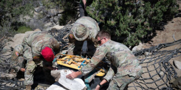 Parachute riggers assigned to 19th Special Forces Group (Airborne) stack an encased duck-billed dinosaur skeleton and tools to prepare for an aerial hoist near Escalante National Monument, June 12, 2026. Photo by Staff Sgt. Ian Tracy