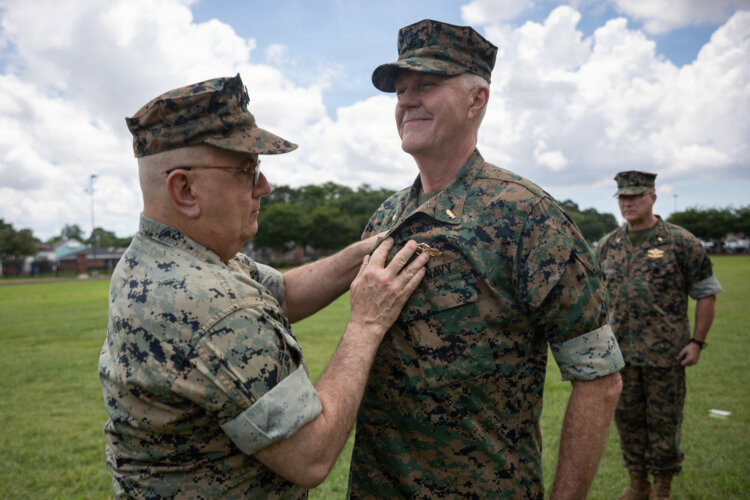 Navy Rear Adm. Anthony Lacourse, reserve medical officer, Marine Forces Reserve, pins Fleet Marine Force insignia on Lt. Cmdr. David Westerberg, a dentist, 4th Dental Battalion, during a Fleet Marine Force (FMF) pinning ceremony at Marine Force Support Facility New Orleans, June 11, 2026.